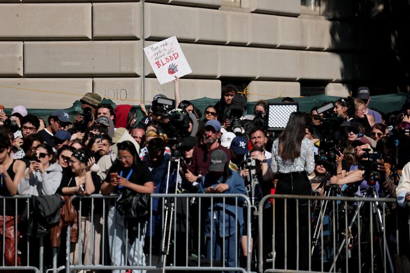 A protester holds up a sign while standing across the street from the Met Gala, an annual fundraising gala held for the benefit of the Metropolitan Museum of Art's Costume Institute with this year's theme 'Costume Art' in New York City, New York, U.S., May 4, 2026.