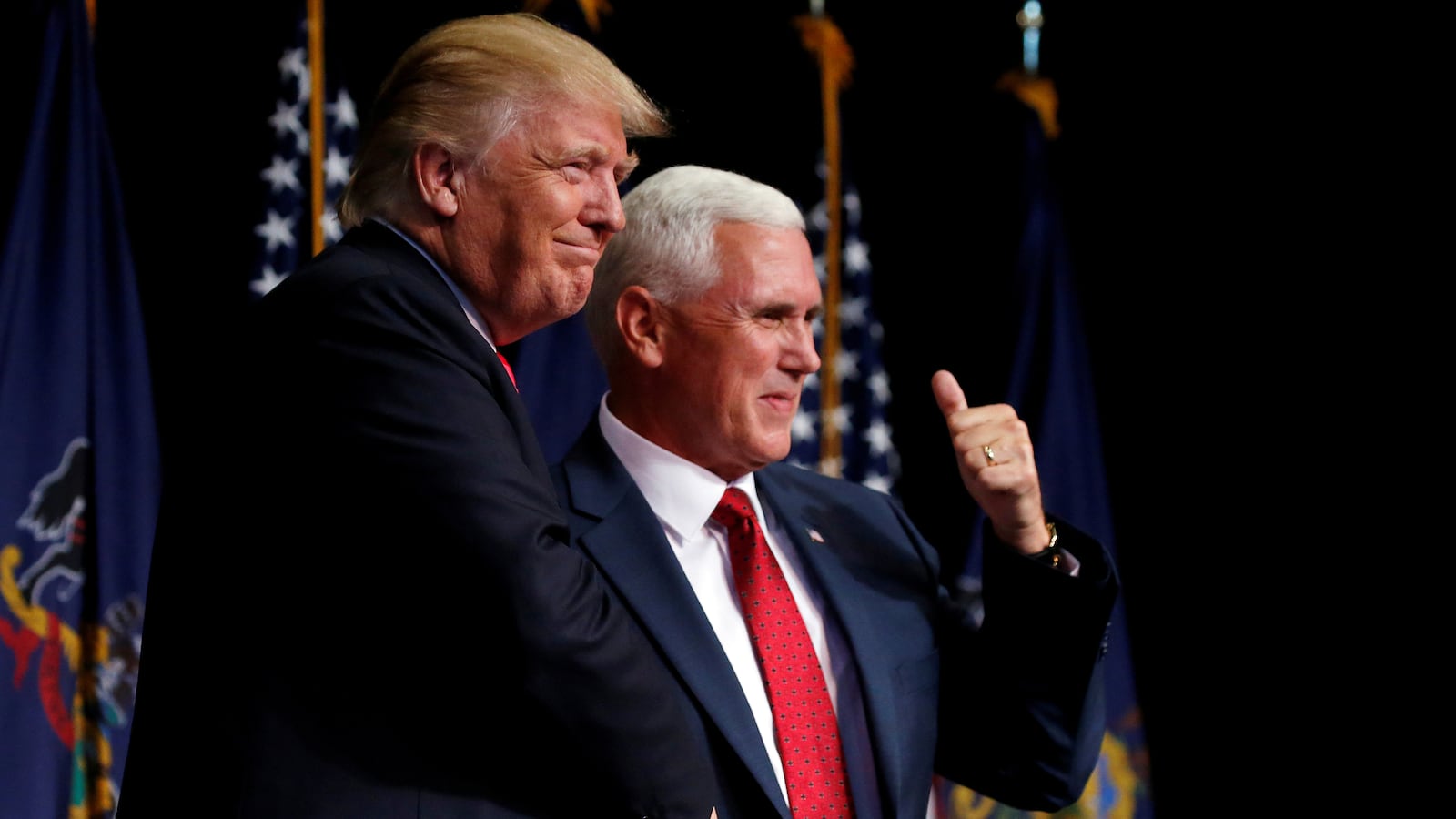 Republican presidential nominee Donald Trump (L) shakes hands with vice presidential nominee Mike Pence at a campaign rally in Scranton, Pennsylvania, U.S. July 27, 2016.