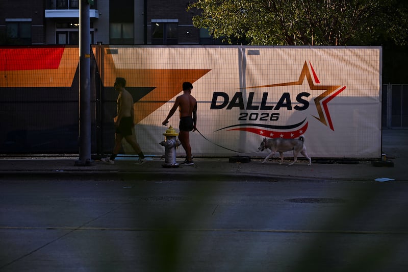People walk past signage that reads "DALLAS 2026" as the final preparations are underway for the Republican National Midterm Convention, in Dallas, Texas, U.S., September 8, 2026. REUTERS/Callaghan O'Hare