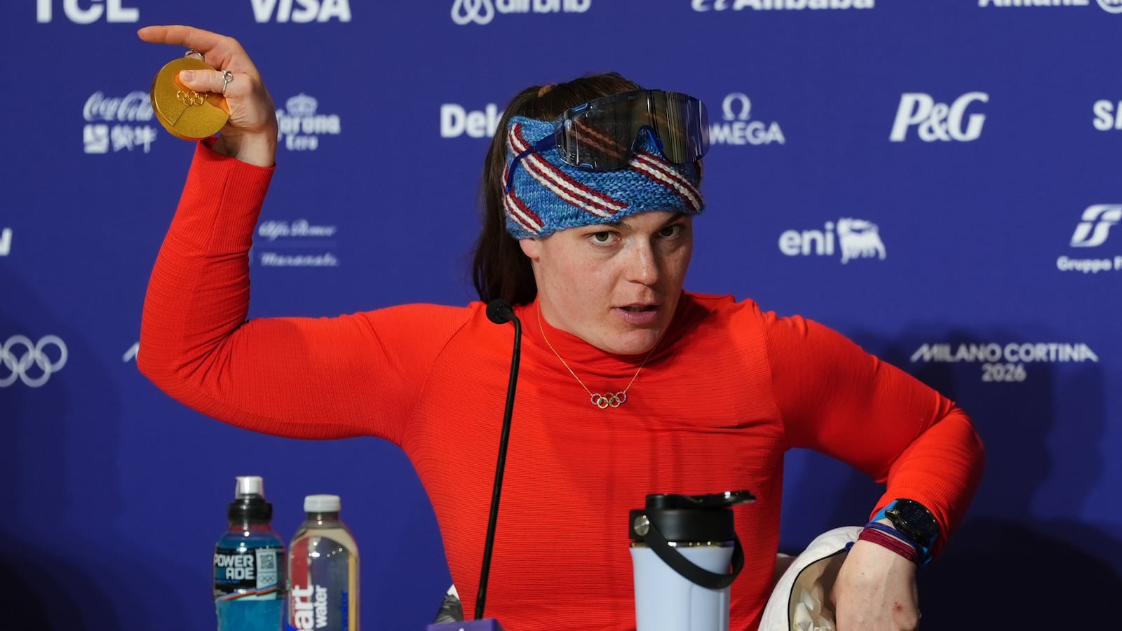 Gold medallist USA's Breezy Johnson shows her broken medal to the media following the Women's Alpine Downhill Skiing at the Tofane Alpine Skiing Centre, Cortina d'Ampezzo, on day two of the Milano Cortina 2026 Winter Olympics. Picture date: Sunday February 8, 2026. (Photo by Andrew Milligan/PA Images via Getty Images)
