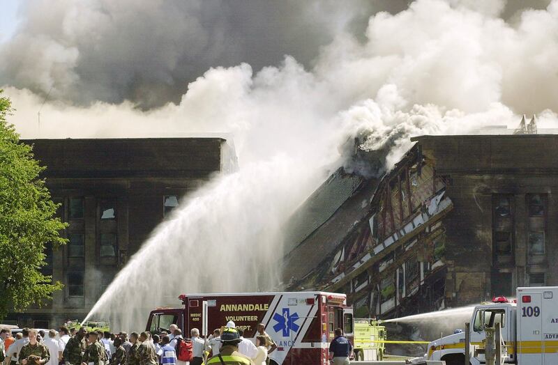 Firefighters struggle to contain the fire after the hijacked American Airlines Flight 77 crashed into the Pentagon on September 11, 2001.