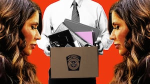 Kristi Noem in front of a man holding a box of items from his office after being fired