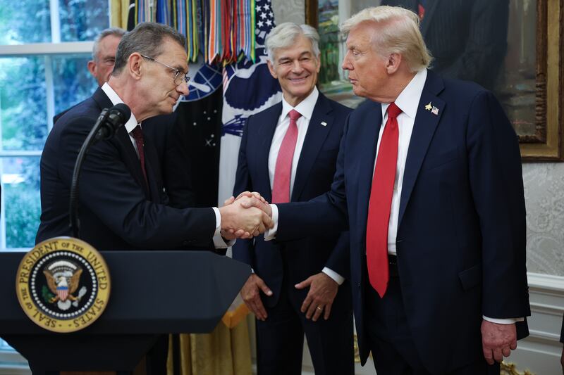 Pfizer CEO Albert Bourla speaks shakes hands with President Donald Trump after they announced a deal with Pfizer to lower Medicaid drug prices in the Oval Office on September 30, 2025.