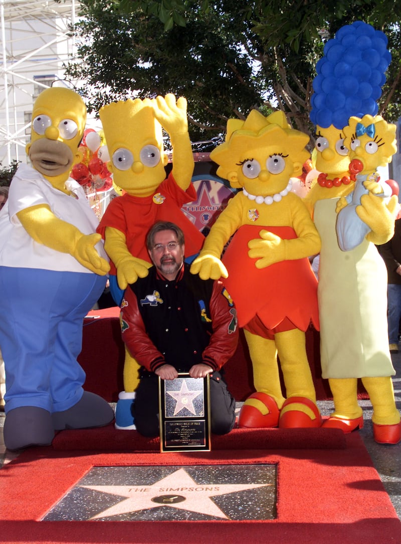 Animated characters from "The Simpsons" pose with their star on the Hollywood Walk of Fame, Janaury 14 during ceremonies along Hollywood Boulevard with Simpsons creator Matt Groening. The Simpsons, the longest running animated comedy series in the history of television, is celebrating its tenth anniversary Janaury 14. Shown (L-R) Homer, Bart, Lisa and Marge (holding baby Maggie.
RMP/HB
