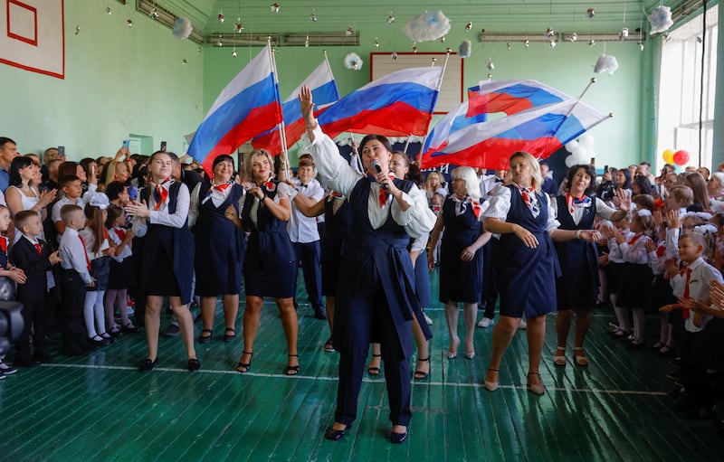 People take part in a ceremony marking the start of a new school year at a lyceum in the course of Ukraine-Russia conflict in Donetsk, Russian-controlled Ukraine, September 2, 2024.
