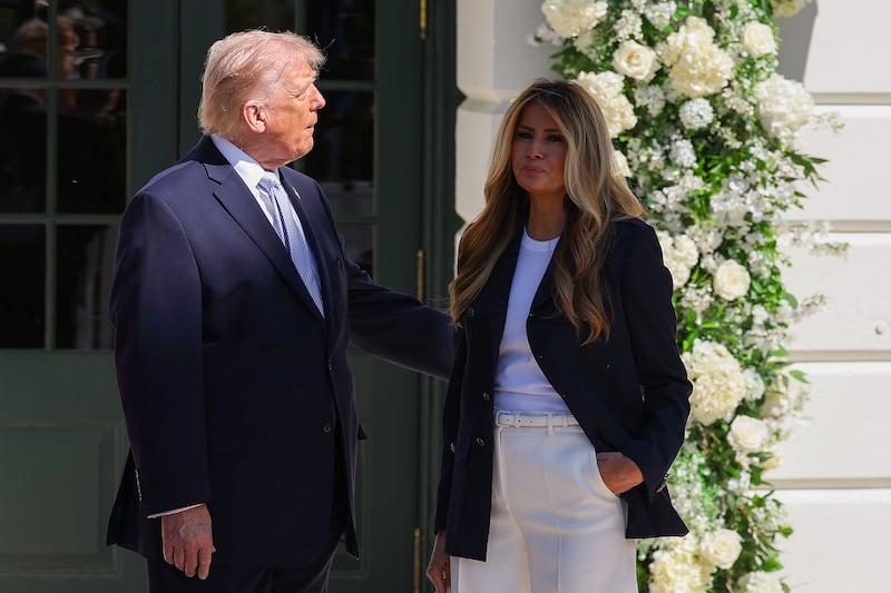 WASHINGTON, DC - APRIL 06: U.S. President Donald Trump, with First Lady Melania Trump, waits to greet guests at the White House Easter Egg Roll on the South Lawn on April 06, 2026 in Washington, DC. The Easter Egg Roll is a White House tradition dating back to 1878. The Trumps also honored the 250th anniversary of the United States during the event. (Photo by Anna Moneymaker/Getty Images)