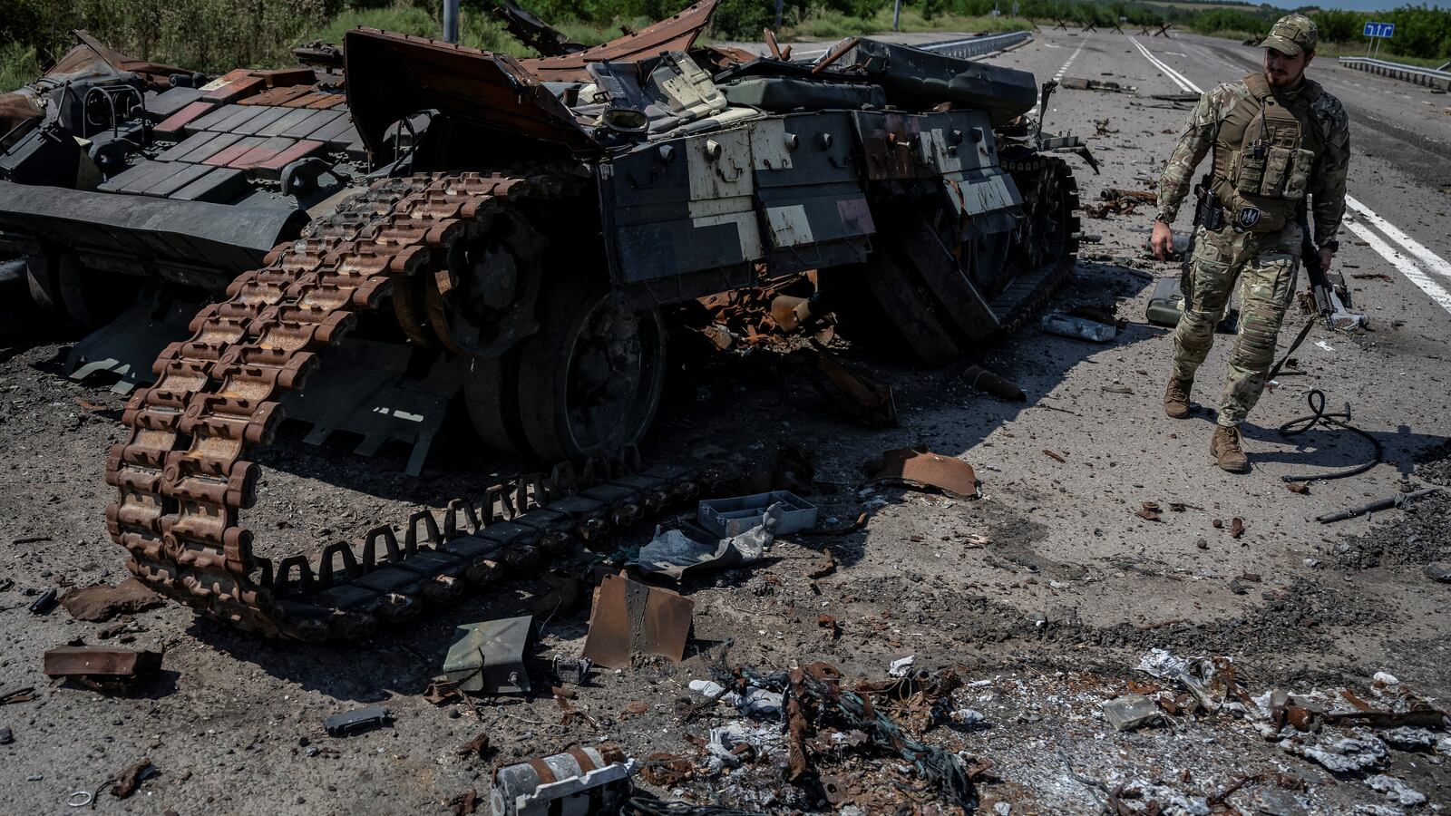 A Ukrainian serviceman walks near a destroyed Ukrainian tank near the village of Robotyne, Zaporizhzhia region, Ukraine, Aug. 25, 2023.
