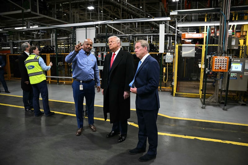 President Donald Trump speaks with Ford executive chairman Bill Ford (R) and plant manager Corey Williams as he tours Ford Motor Company's River Rouge complex in Dearborn, Michigan, on January 13, 2026.