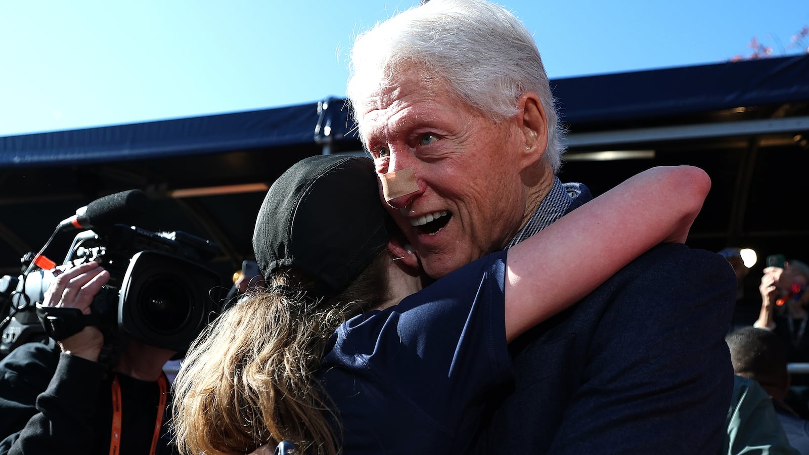 Former US President Bill Clinton greets Chelsea Clinton at the finish line during the 2025 TCS New York City Marathon