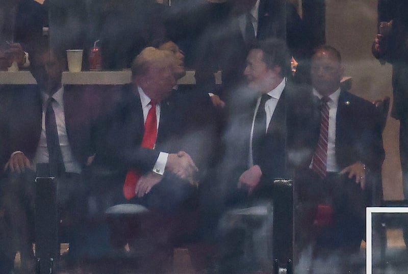 US President Donald Trump and Tesla CEO Elon Musk shake hands during the public memorial service for right-wing activist Charlie Kirk