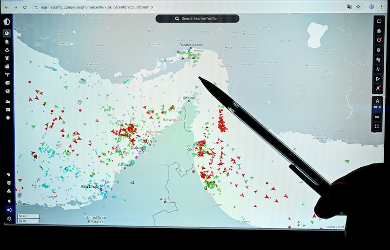 A person points at a page on the Marinetraffic website that shows commercial boats traffic on the edge of the Strait of Hormuz near the Iranian coast, in Paris on March 4, 2026. (Photo by JULIEN DE ROSA / AFP via Getty Images)