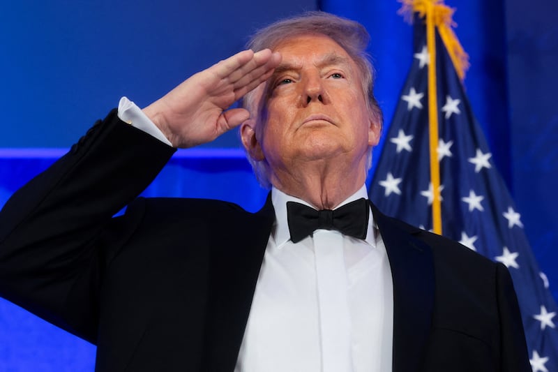 Trump salutes at the White House Correspondents' Association (WHCA) Dinner.