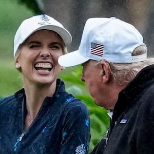 U.S. Interior Secretary Doug Burgum and Executive assistant to U.S. President Donald Trump Natalie Harp speak with Donald Trump during a visit at a golf course at Hains Point in Washington, D.C., U.S., June 28, 2026. REUTERS/Ken Cedeno     TPX IMAGES OF THE DAY