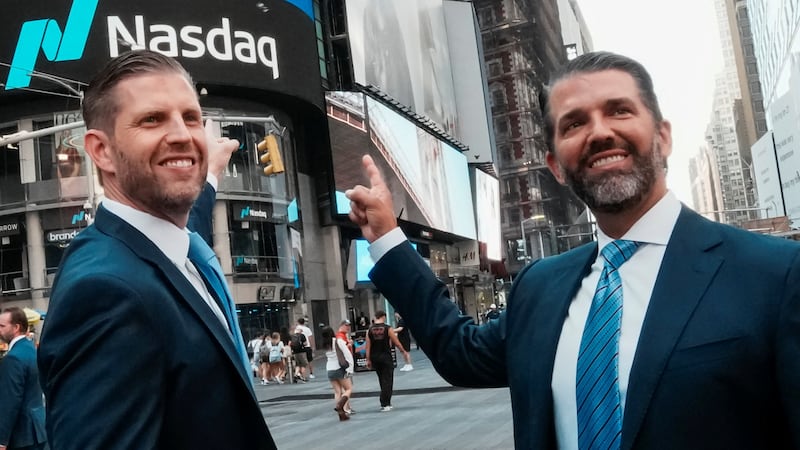 Donald Trump Jr. and Eric Trump pose for pictures outside the Nasdaq building after ringing the opening bell to celebrate the closing of ALT5’s $1.5 billion offering and adoption of its $WLFI Treasury Strategy at the Nasdaq Market, in New York City, U.S., August 13, 2025.  REUTERS/Eduardo Munoz