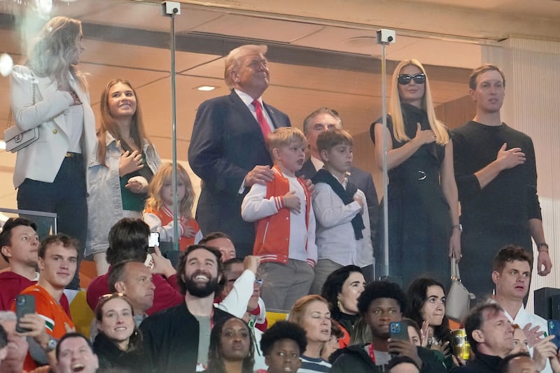 Jan 19, 2026; Miami Gardens, FL, USA; Lara Trump, Kai Trump, United States President Donald Trump, Ivanka Trump, and Jared Kushner look on during the national anthem before the CFP National Championship college football game between the Indiana Hoosiers and the Miami Hurricanes at Hard Rock Stadium. Mandatory Credit: Kirby Lee-Imagn Images