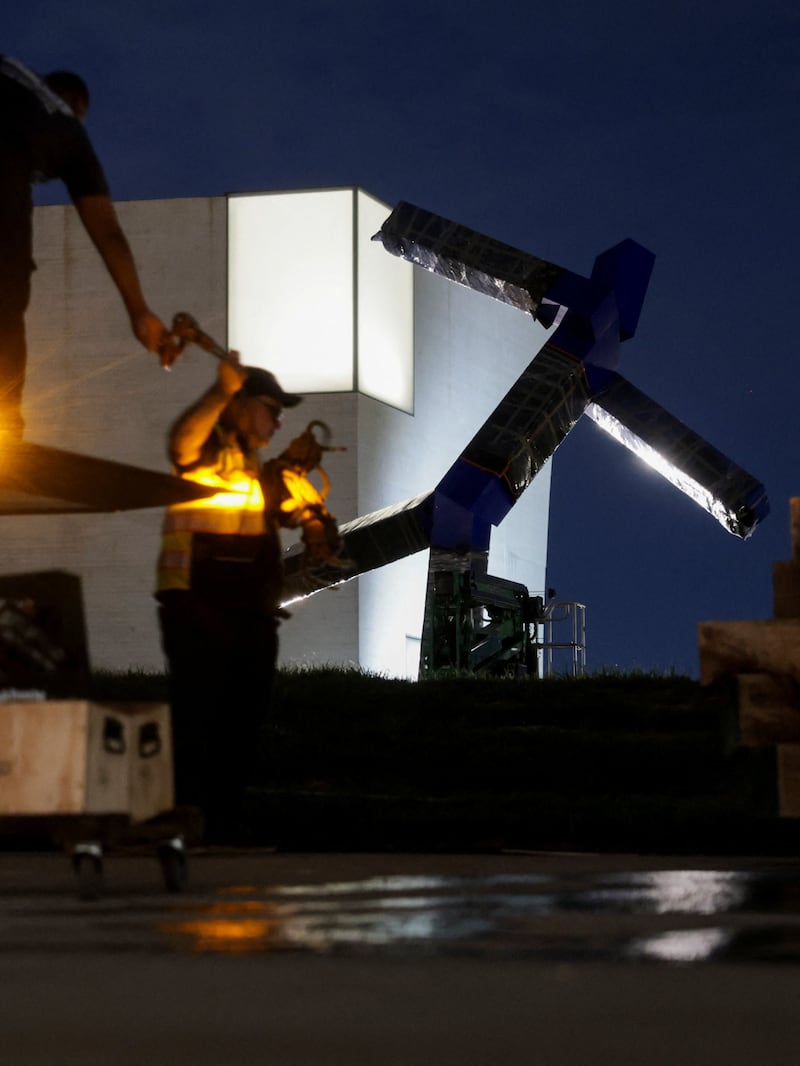 Workers prepare their gear before the beginning of the removal of the sculpture titled "Blue" by artist Joel Shapiro from the grounds of the Kennedy Center for the Performing Arts, after it was targeted for removal by the Trump administration, in Washington, D.C. on September 2, 2026.