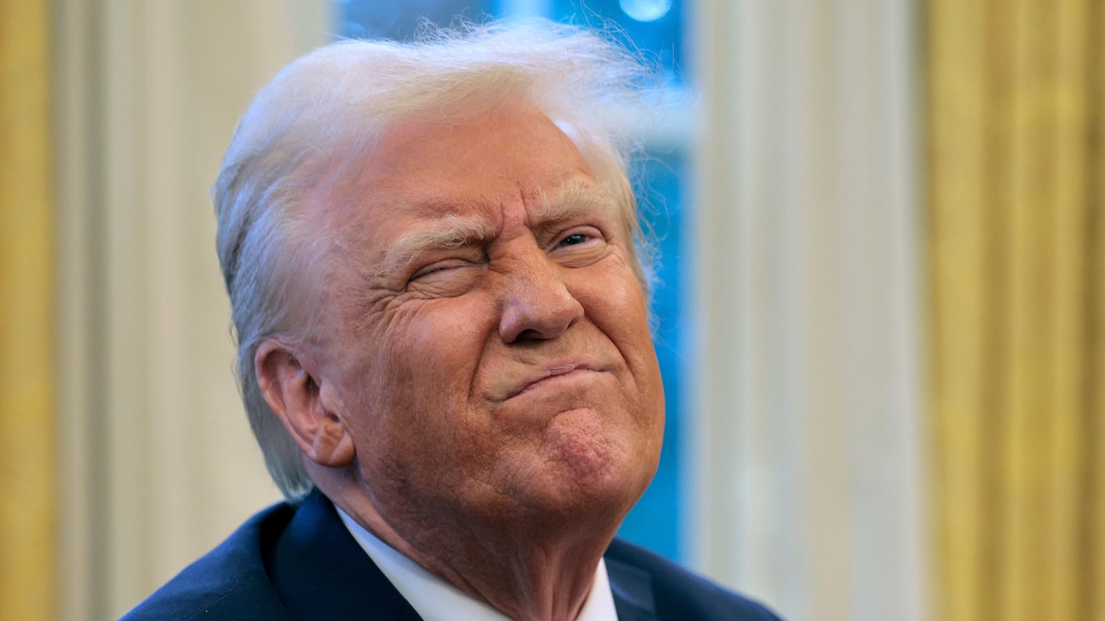 President Donald Trump reacts to a reporter's question from the Resolute Desk after signing an executive order to appoint the deputy administrator of the Federal Aviation Administration in the Oval Office at the White House on January 30, 2025 in Washington, DC.