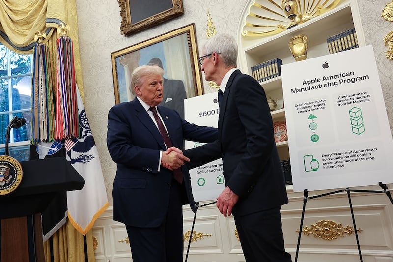 WASHINGTON, DC - AUGUST 06: U.S. President Donald Trump (L) shakes hands with Apple CEO Tim Cook during an event in the Oval Office of the White House on August 6, 2025 in Washington, DC. Apple Inc. announced a $100 billion investment in manufacturing facilities in the U.S., on top of an announcement in February committing over the next four years to a $500 billion investment in the U.S. economy and the addition of 20,000 new jobs. (Photo by Win McNamee/Getty Images)