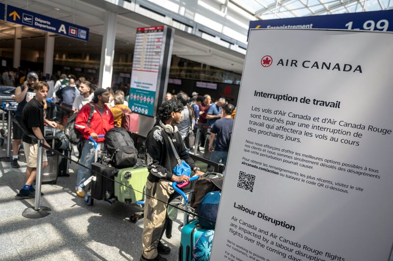 Queues outside an Air Canada check-in desk.