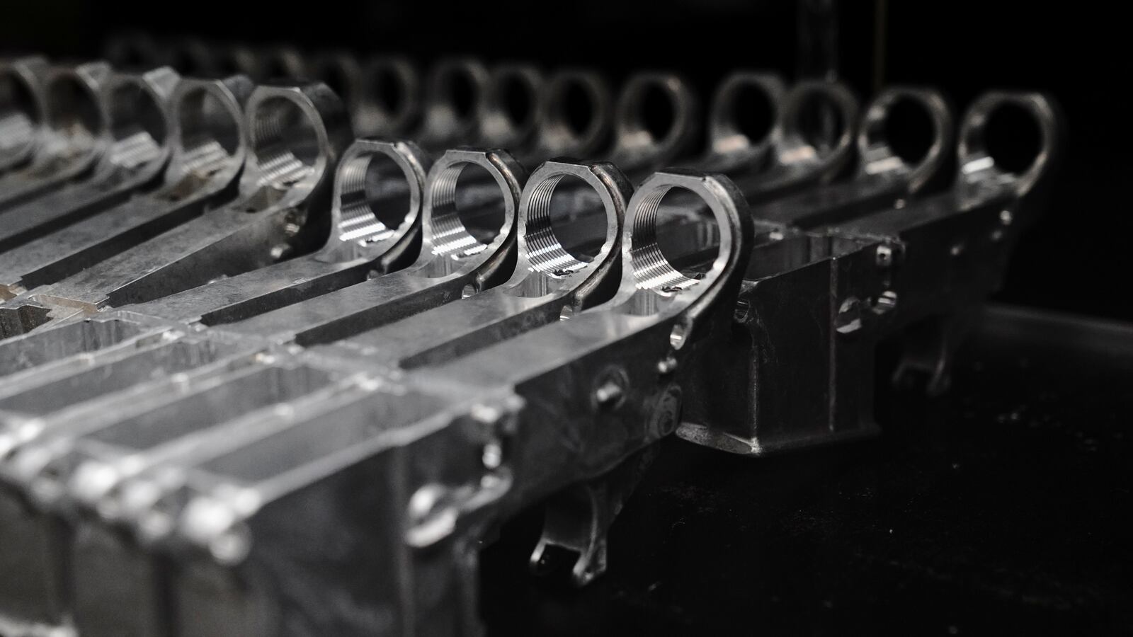 Aluminum 80% lower receivers for AR-15 rifles are displayed for sale at Firearms Unknown, a gun store in Oceanside, California.