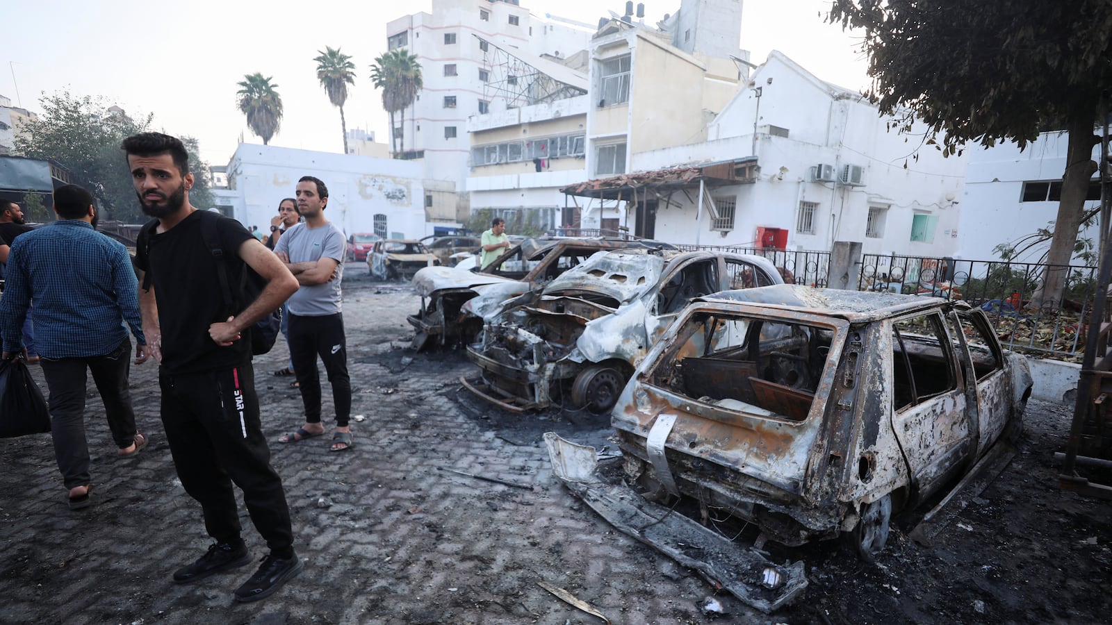 People inspect the area of Al-Ahli hospital where hundreds of Palestinians were killed in a blast that Israeli and Palestinian officials blamed on each other, in Gaza City, Oct. 18, 2023.
