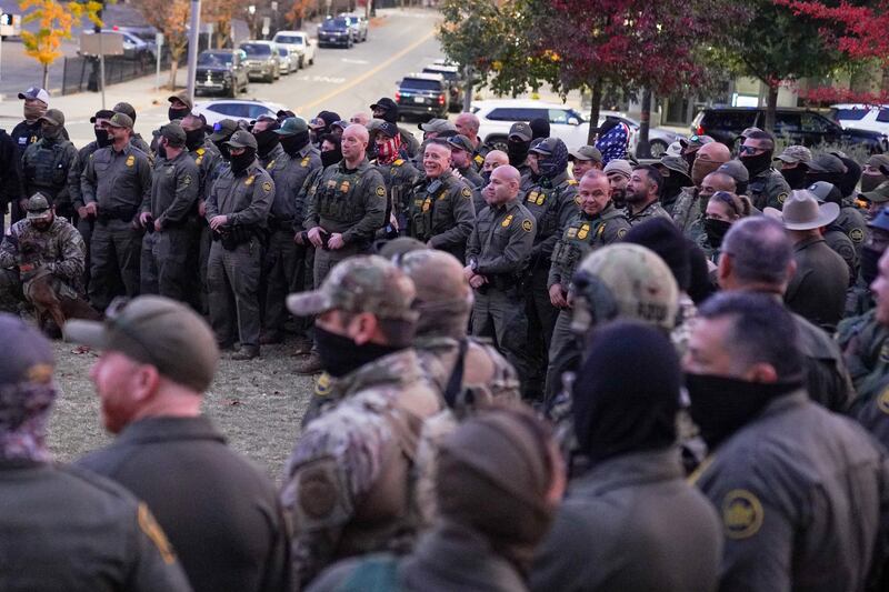 Federal Agents, led by Chief Border Patrol Agent Greg Bovino, gather in a park in Downtown Charlotte to take a group photograph.