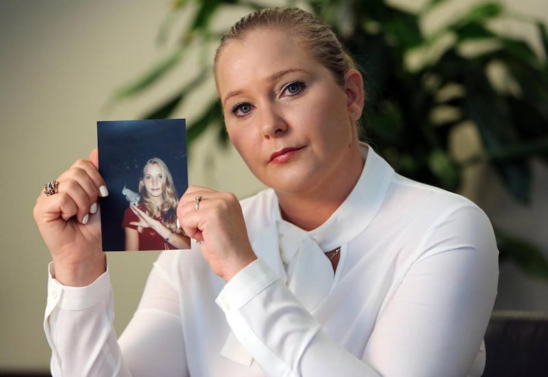 Virginia Giuffre, with a photo of herself as a teen, when she says she was abused by Jeffrey Epstein, Ghislaine Maxwell and Prince Andrew, among others. (Emily Michot/Miami Herald/Tribune News Service via Getty Images)