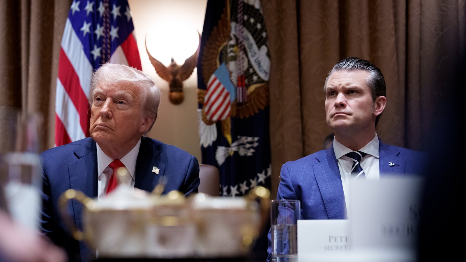Donald Trump and Pete Hegseth appear during a Cabinet meeting at the White House on Feb. 25.