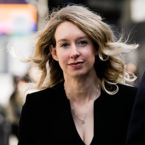 SAN JOSE, CA - MARCH 17: Former Theranos CEO Elizabeth Holmes alongside her boyfriend Billy Evans, walks back to her hotel following a hearing at the Robert E. Peckham U.S. Courthouse on March 17, 2023 in San Jose, California. Holmes appeared in court for a restitution hearing. (Photo by Philip Pacheco/Getty Images)