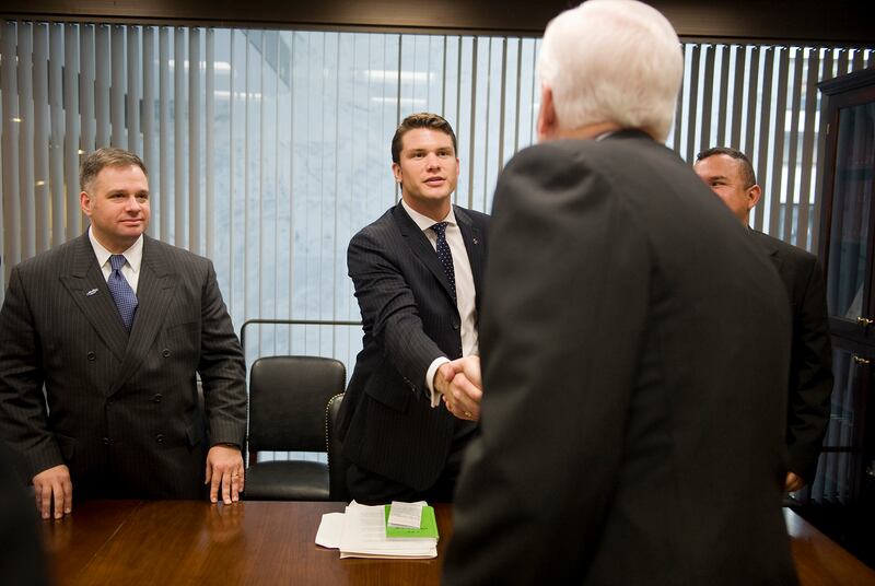 Sen. John Cornyn, back to camera, greets Pete Hegseth, center, of Veterans for Freedom, and veterans from other wars, who were visiting Hill offices to voice their support for the troops in a Afghanistan and ask that the generals on the ground are granted the resources they need, Nov. 5, 2009.