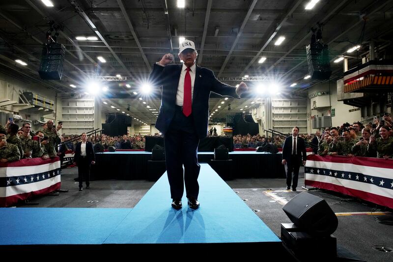 President Donald Trump dances as he prepares to depart after speaking to troops aboard the USS George Washington on October 28, 2025 in Yokosuka, Japan.