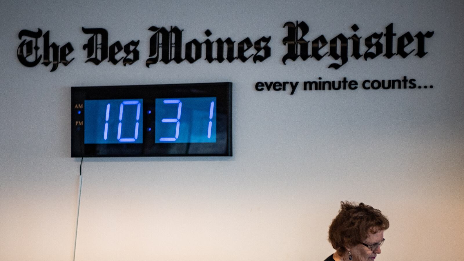 DES MOINES, IOWA - JANUARY 29: The Des Moines Register's Executive Editor Carol Hunter walks under the newspaper's logo with a clock on Wednesday, January 29, 2020 in Des Monies, Iowa. (Photo by Salwan Georges/The Washington Post via Getty Images)