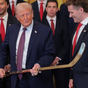 WASHINGTON, DC - JANUARY 15: Aleksander Barkov (L) and Matthew Tkachuk (R) of the Florida Panthers present U.S. President Donald Trump (C) with a jersey and hockey stick during a ceremony to honor the 2025 Stanley Cup Champion Florida Panthers in the East Room of the White House on January 15, 2026 in Washington, DC. The Florida Panthers defeated the Edmonton Oilers for the second straight year in their first-ever championships since joining the NHL in 1993. (Photo by Anna Moneymaker/Getty Images)