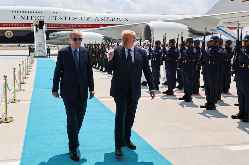 U.S. President Donald Trump walks with Turkish President Tayyip Erdogan as he arrives aboard Air Force One at Etimesgut Air Base, for a NATO summit, in Ankara, Turkey, July 7, 2026. REUTERS/Jonathan Ernst