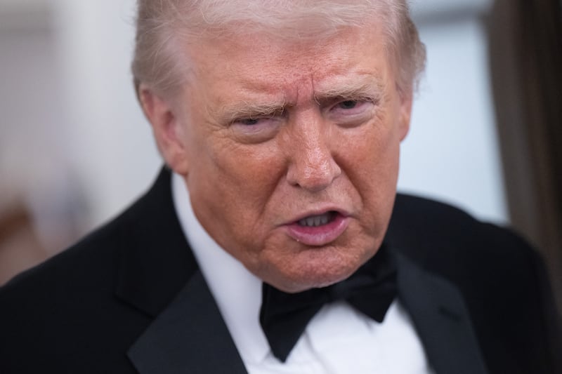 President Donald Trump speaks to members of the media aboard Air Force One as he travels from Washington, DC to West Palm Beach, Florida, on January 31, 2026.