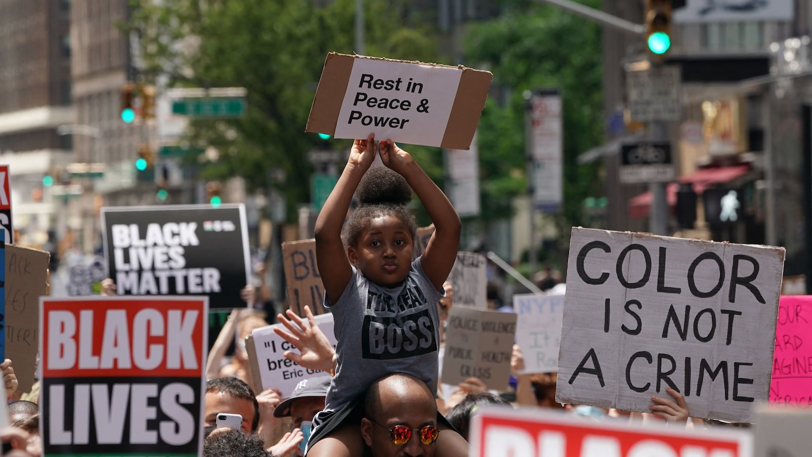 A little girl holds up a sign as “Black Lives Matter” New York protesters demonstrate in Times Square over the death of George Floyd by a Minneapolis police officer on June 7, 2020, in New York.