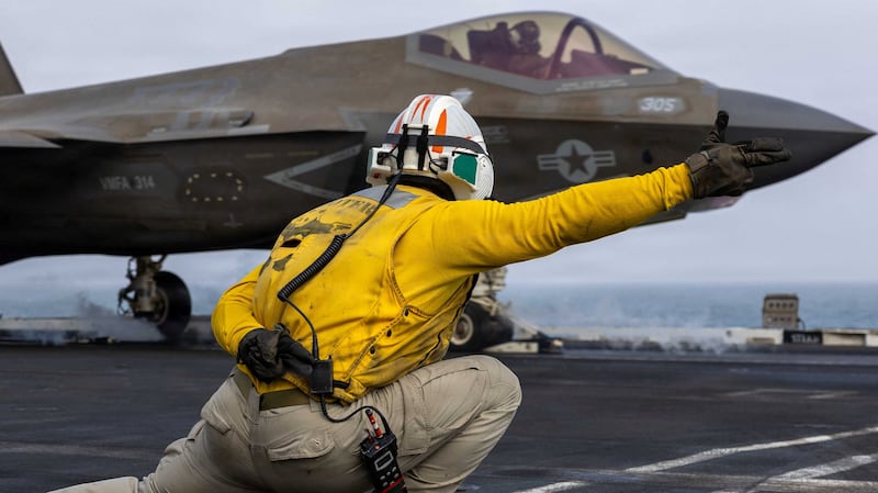 An American sailor directs the pilot of an F-35C Lightning II from the flight deck of the USS Abraham Lincoln earlier this month.