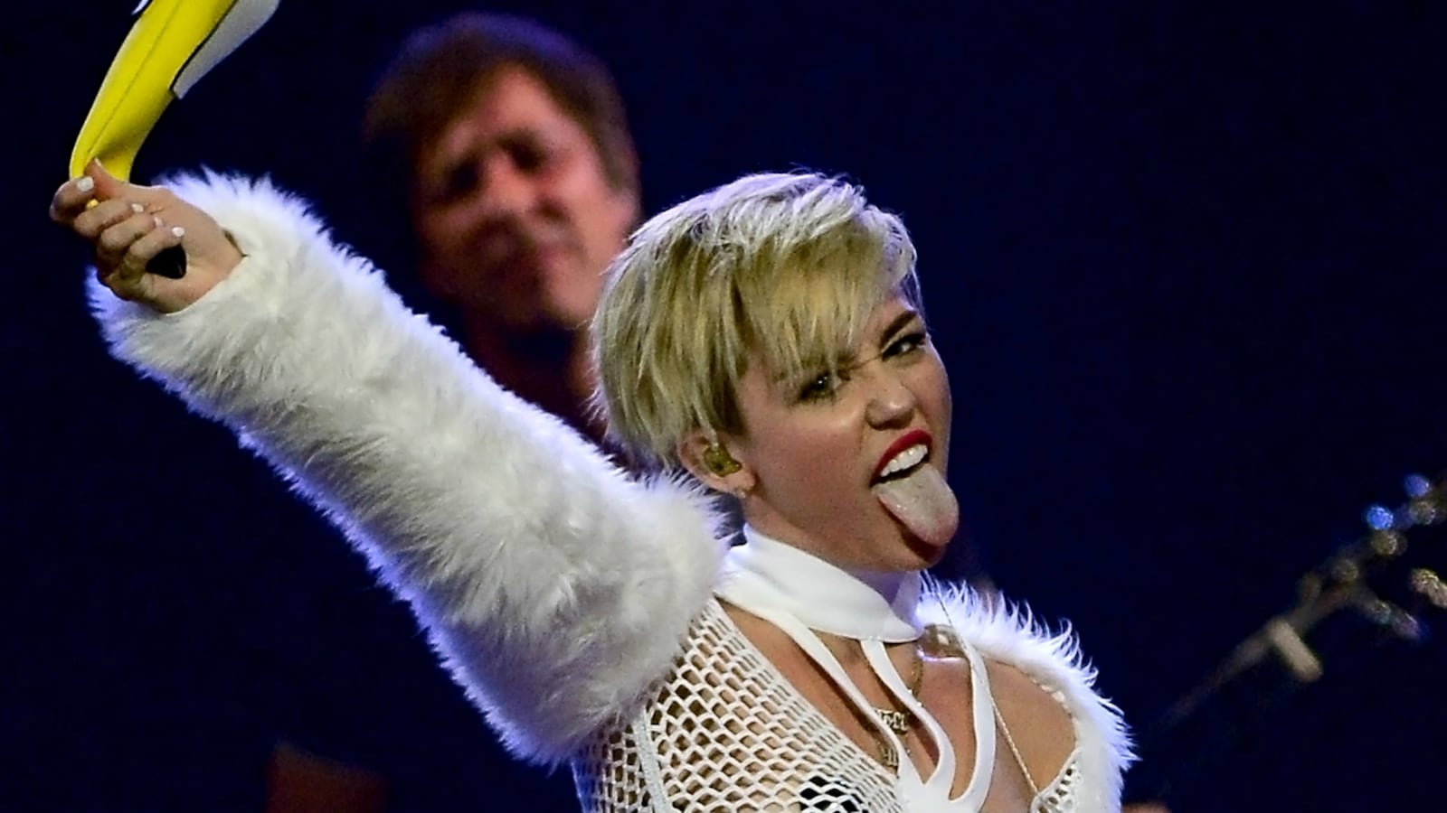 articles/2013/09/24/miley-cyrus-gets-naked-for-rolling-stone-the-voice-ratings-surprise/Miley-Cyrus-i-heart-radio-plus-banana-tease_ifdrdp