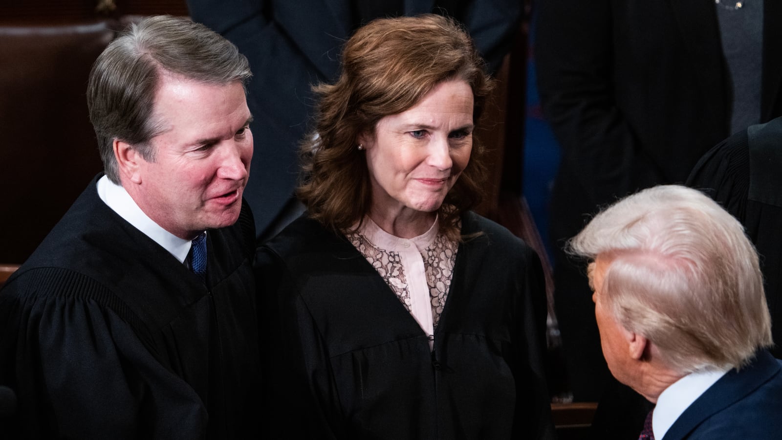 Supreme Court Justices Brett Kavanaugh and Amy Coney Barrett greet President Donald Trump after his address to a joint session of Congress in the House Chamber of the U.S. Capitol on Tuesday, March 4, 2025.