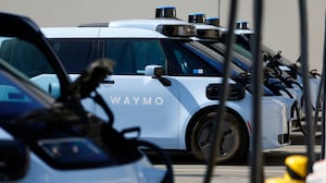 Waymo electric autonomous ride-hailing service vehicles are charged at a private charging station on September 14, 2026 in San Diego, CA.