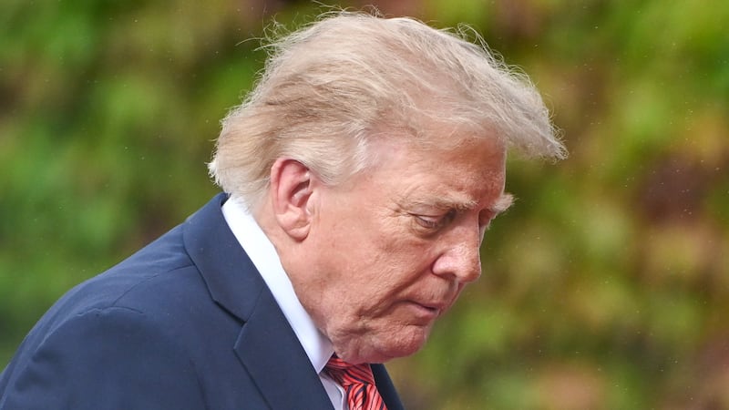 DUBLIN, IRELAND - SEPTEMBER 12: U.S. President Donald Trump walks with a downcast expression across the lawns of Aras an Uachtarain as he departs following his official state talks on September 12, 2026, in Dublin, Ireland. (Photo by Artur Widak/NurPhoto via Getty Images)