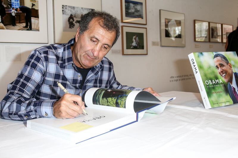 Photographer Pete Souza signs his book 'Obama: An Intimate Portrait'