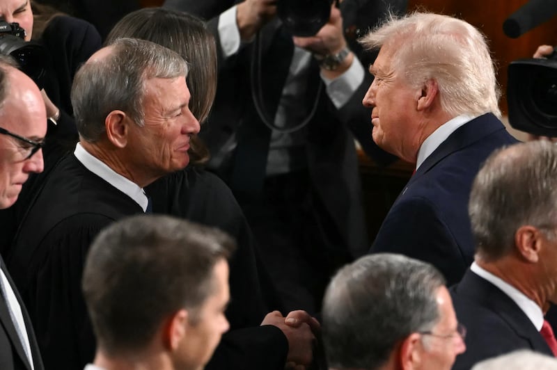 President Donald Trump shakes hands with Supreme Court Chief Justice John Roberts as he arrives to deliver his State of the Union address in the House Chamber of the US Capitol in Washington, DC, on February 24, 2026.