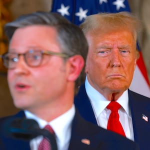 President Donald Trump listens as  Mike Johnson speaks during a press conference at Mr. Trump's Mar-a-Lago estate on April 12, 2024, in Palm Beach, Florida.