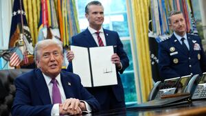 President Donald Trump speaks to the media after signing an executive order renaming the Department of Defense to the Department of War as U.S. Defense Secretary Pete Hegseth and Chairman of the Joint Chiefs of Staff Air Force Gen. Dan Caine look on.