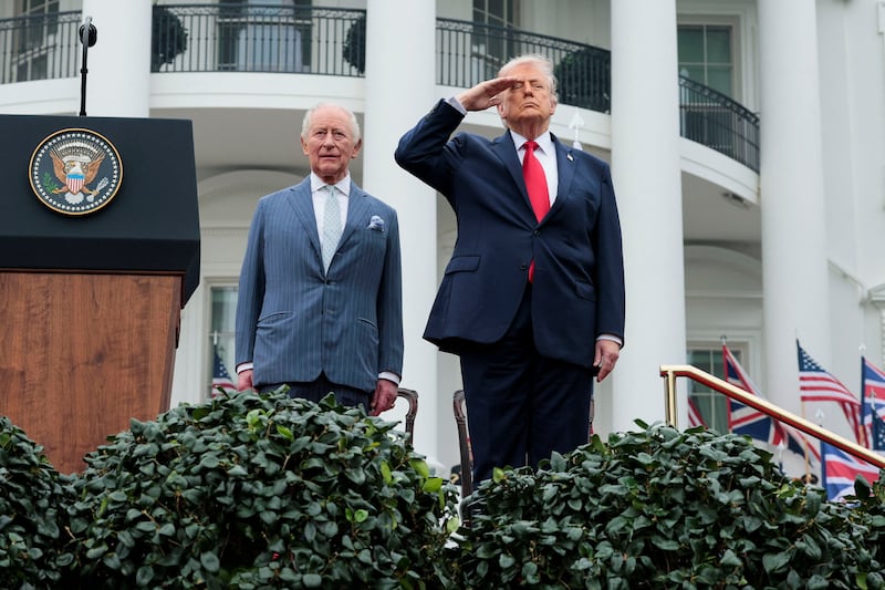 U.S. President Donald Trump salutes next to Britain's King Charles during an arrival ceremony on the South Lawn of the White House in Washington, D.C., U.S., April 28, 2026.