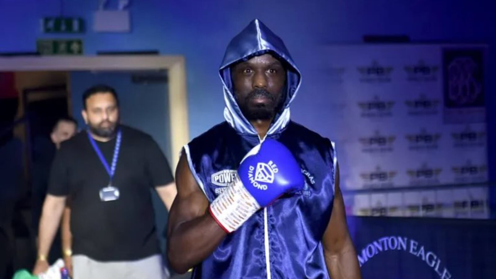 Sherif Lawal raises his right arm before his debut fight.