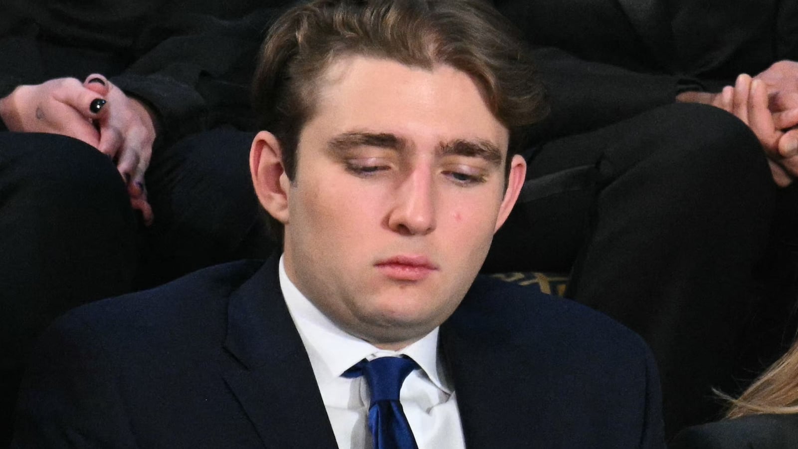 (L/R) Ivanka Trump, Barron Trump, and US First Lady Melania Trump listen as US President Donald Trump delivers the State of the Union address in the House Chamber of the US Capitol in Washington, DC, on February 24, 2026.