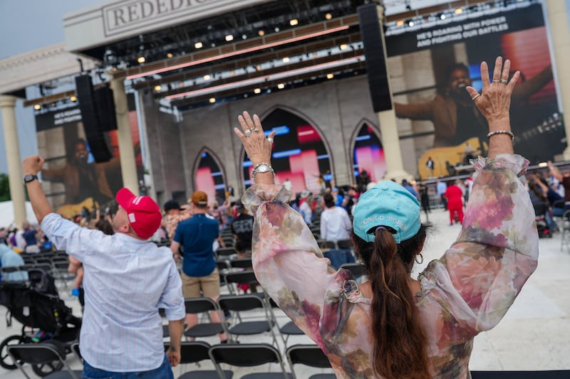Plenty of space as an attendee wearing a "Donald Trump" hat participates in Rededicate 250: National Jubilee of Prayer, Praise & Thanksgiving on the National Mall.