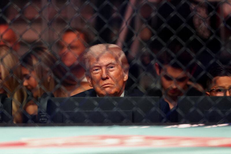 U.S. President Donald Trump watches a match during the UFC 327 event at Kaseya Center in Miami, Florida, U.S., April 11, 2026.  REUTERS/Kevin Lamarque